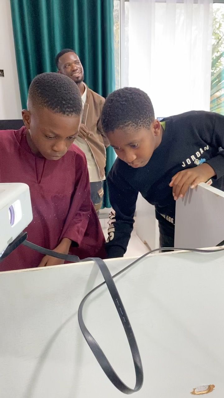 Two students working through a problem together at a workstation