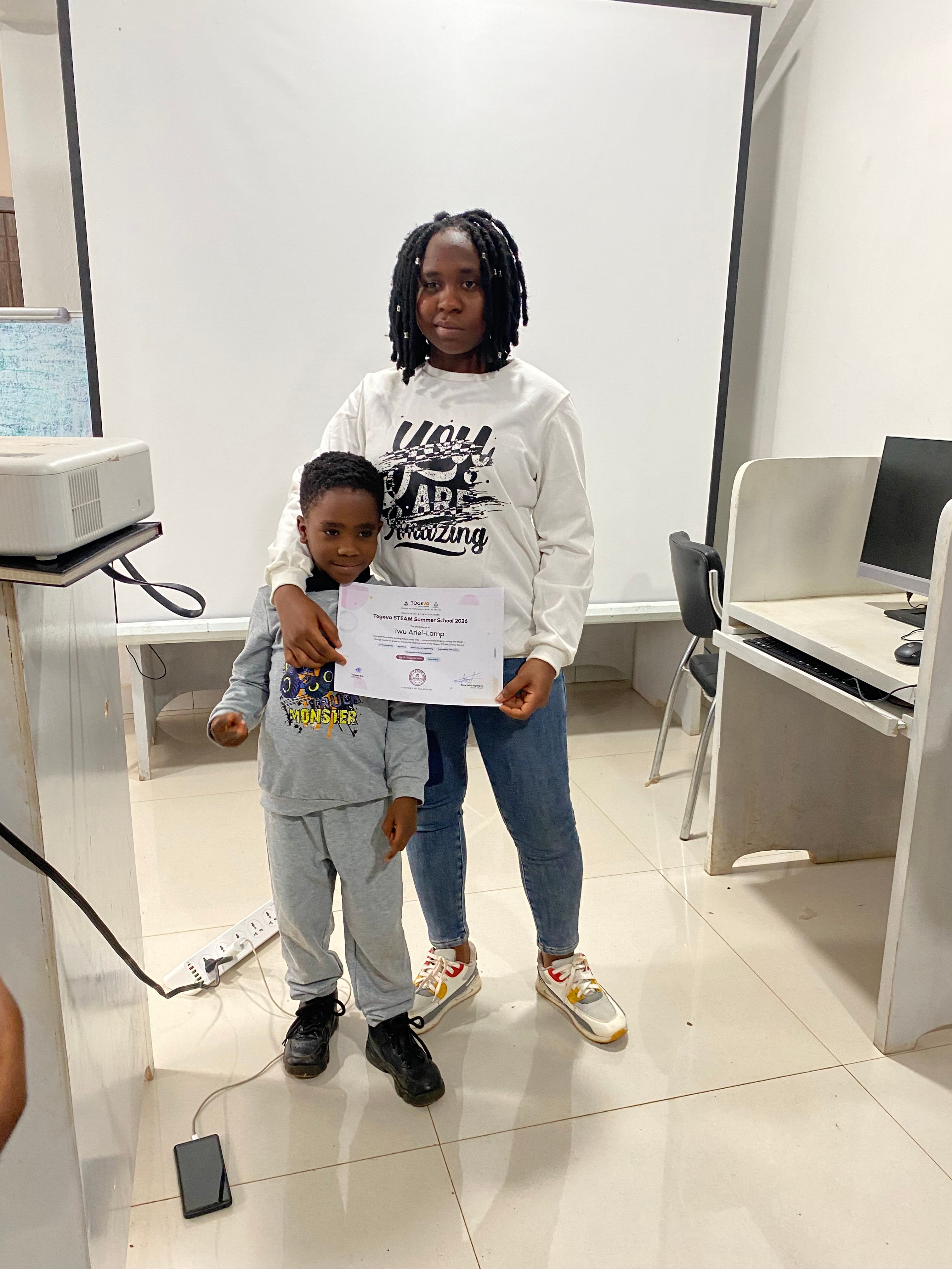 Lamp with her Togeva STEAM Summer School 2026 certificate