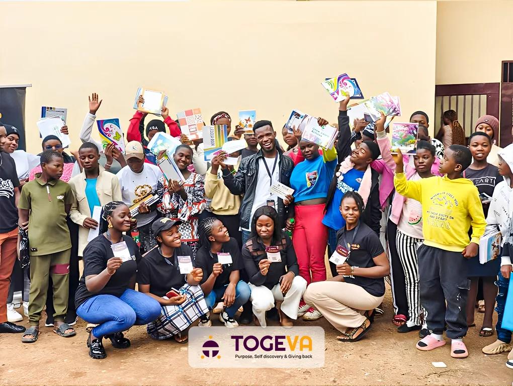 Students holding up their new school supplies with the Togeva and BNM Foundation team