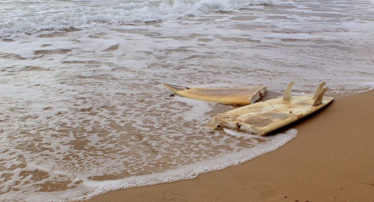 Broken surfboard on the beach