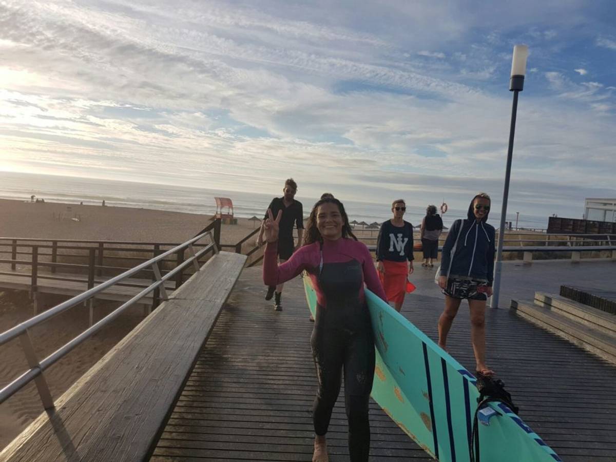 Daniela coming back after a paddleboarding session near our surf house in Ericeira