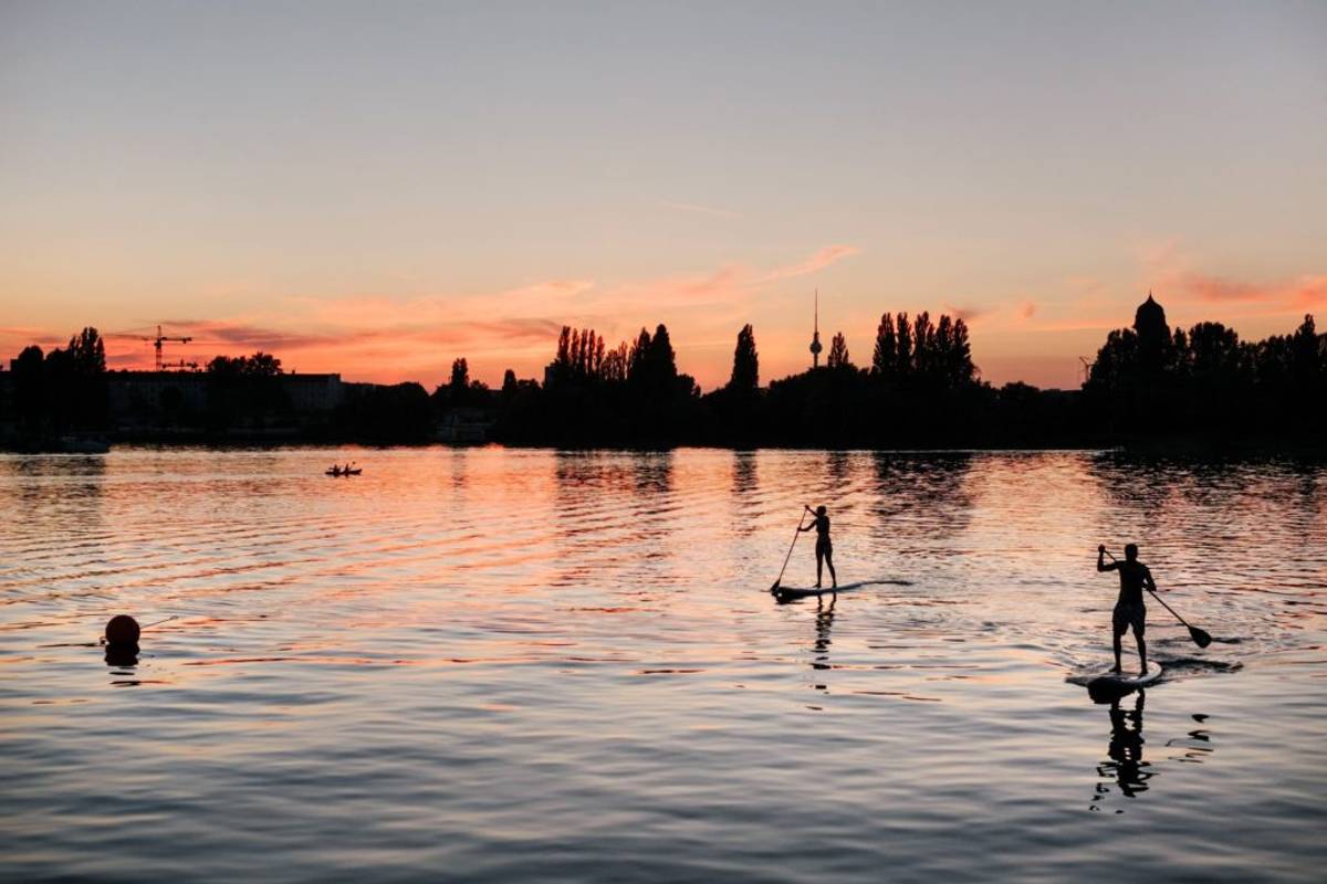 Two people paddleboarding on a lake