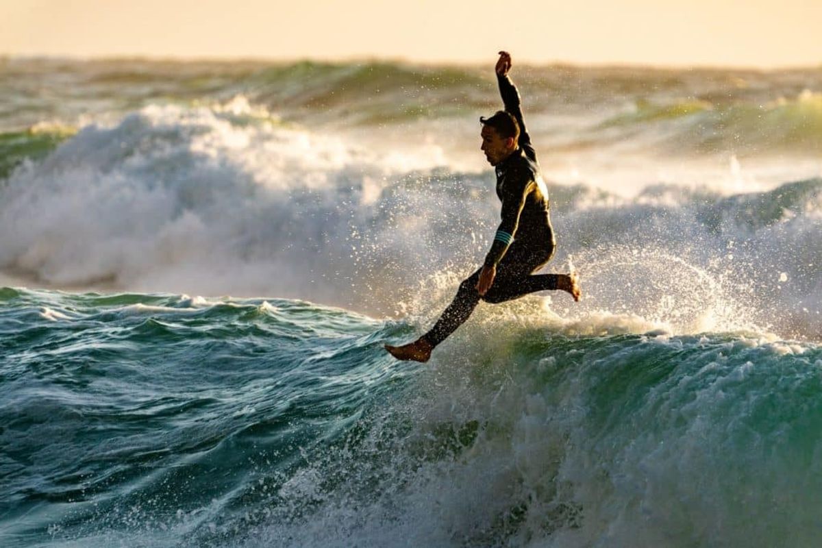 Surfer jumping off his board