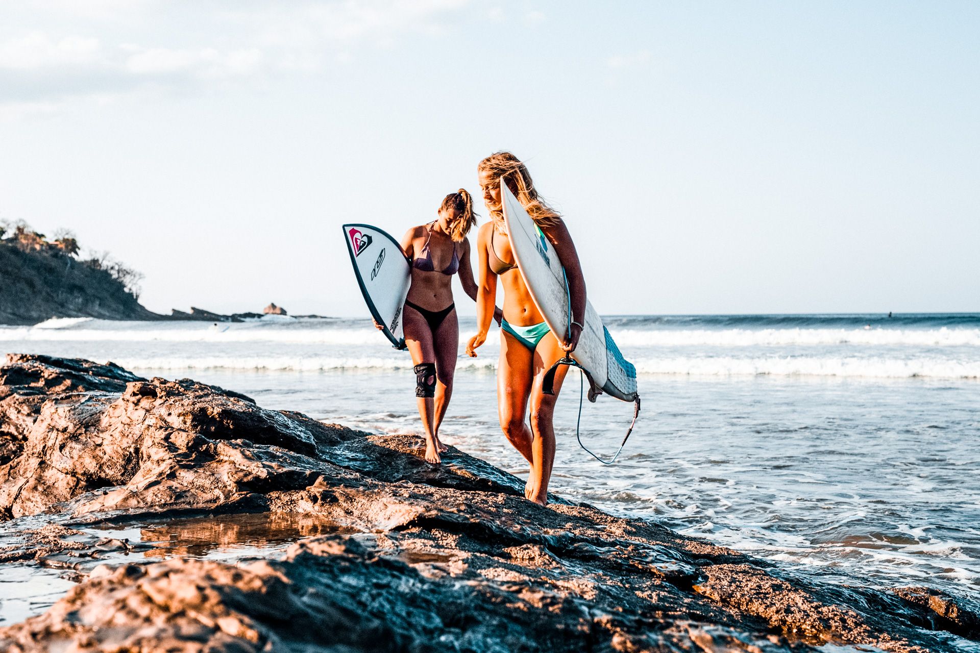 Girls walking on rocks after Surfing with Rapturecamps
