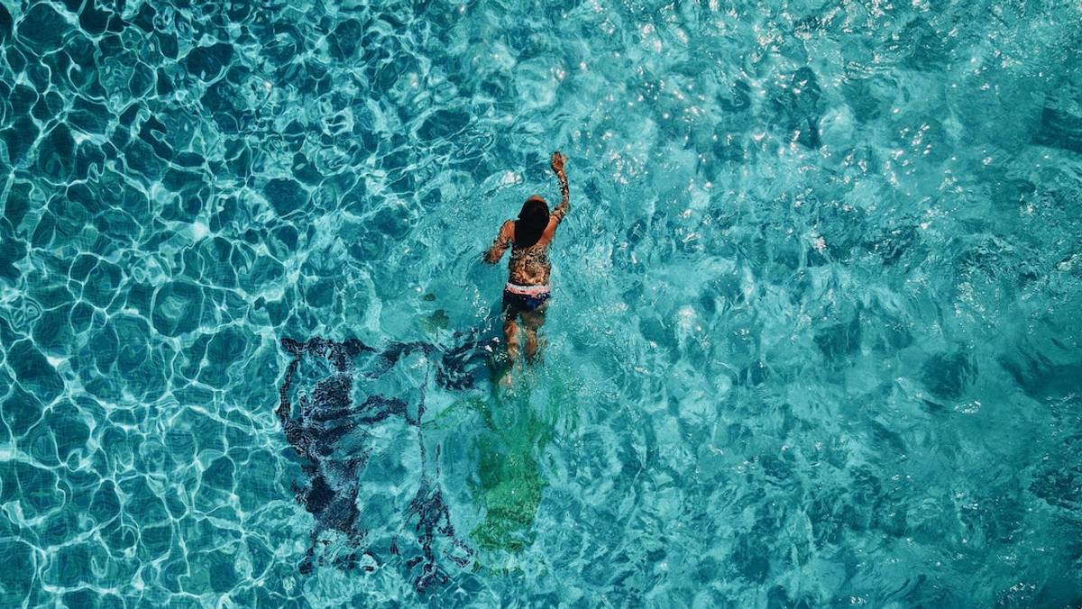 Girl swimming in pristine water