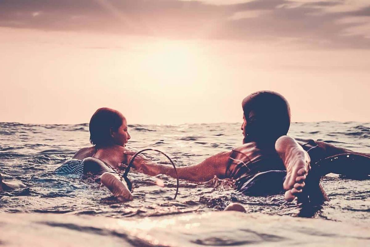 Kid and dad surfing together