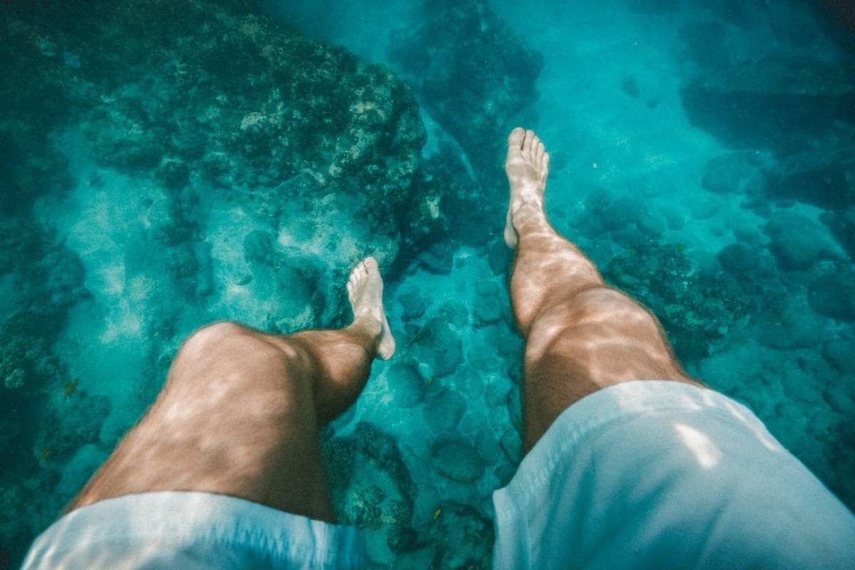 Close up on a guy's feet under water