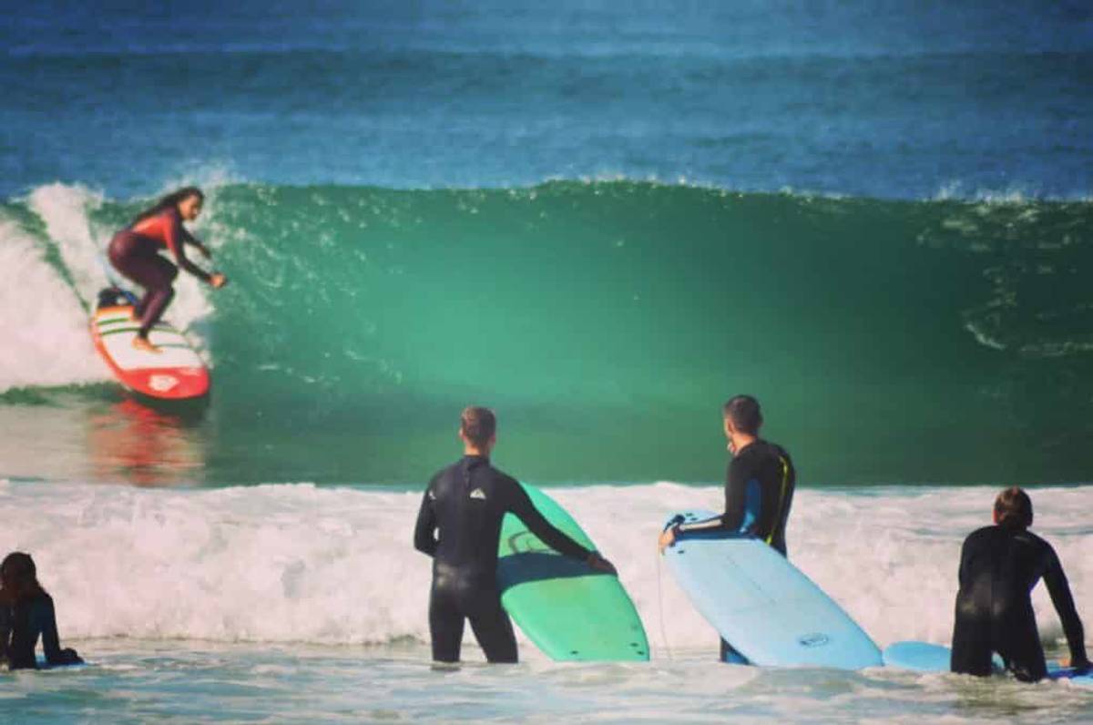 Daniela catching a wave near our surf house in Ericeira