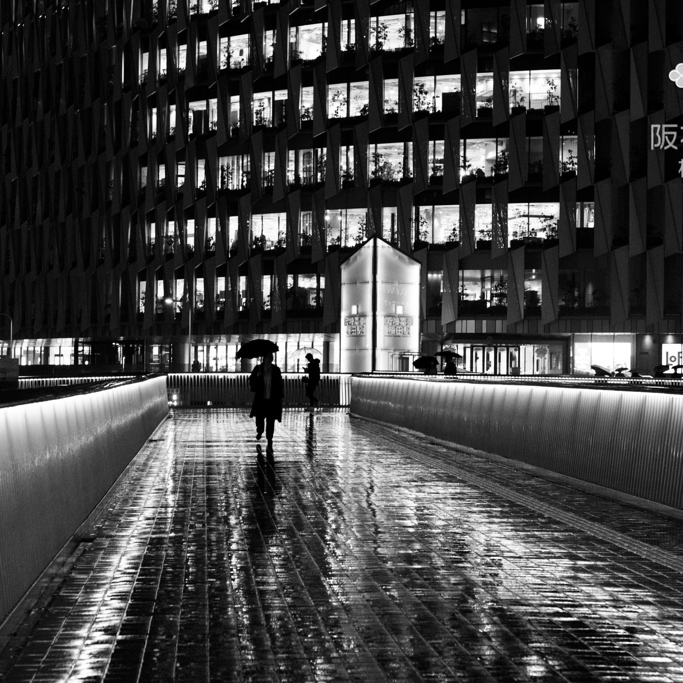 People scurrying home during evening rain in Osaka