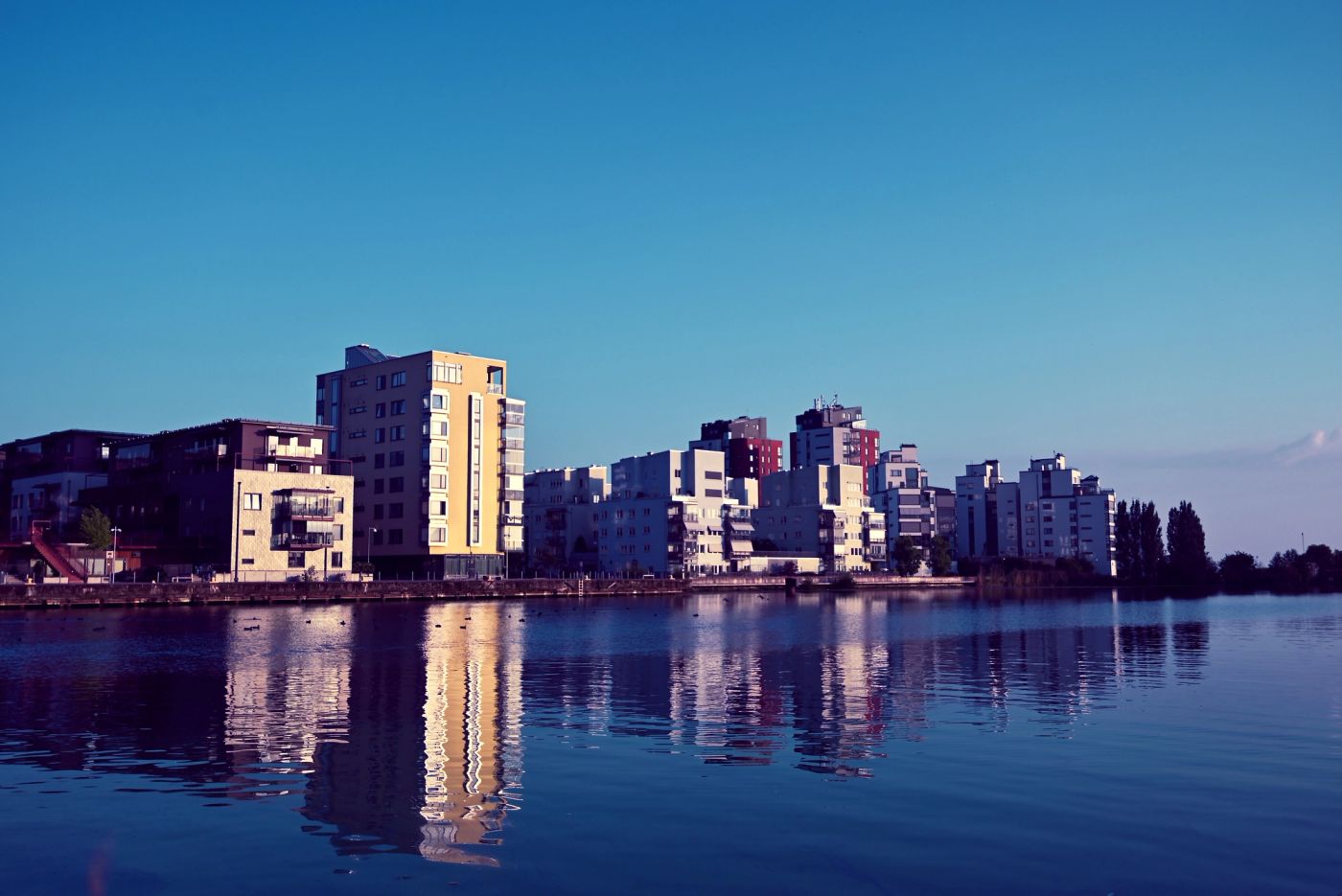 Buildings by the Lake Mälaren, golden hour perfectly captures the serenity of the moment,