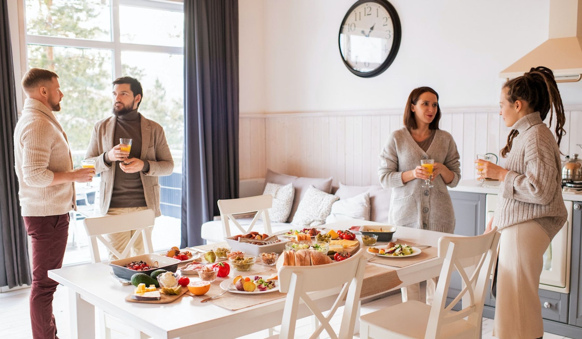 Two men and two women chatting around a breakfast table