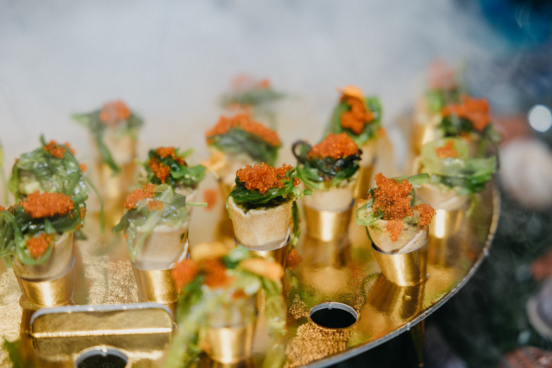 Delicately rolled seaweed and roe wrap on a gold plate