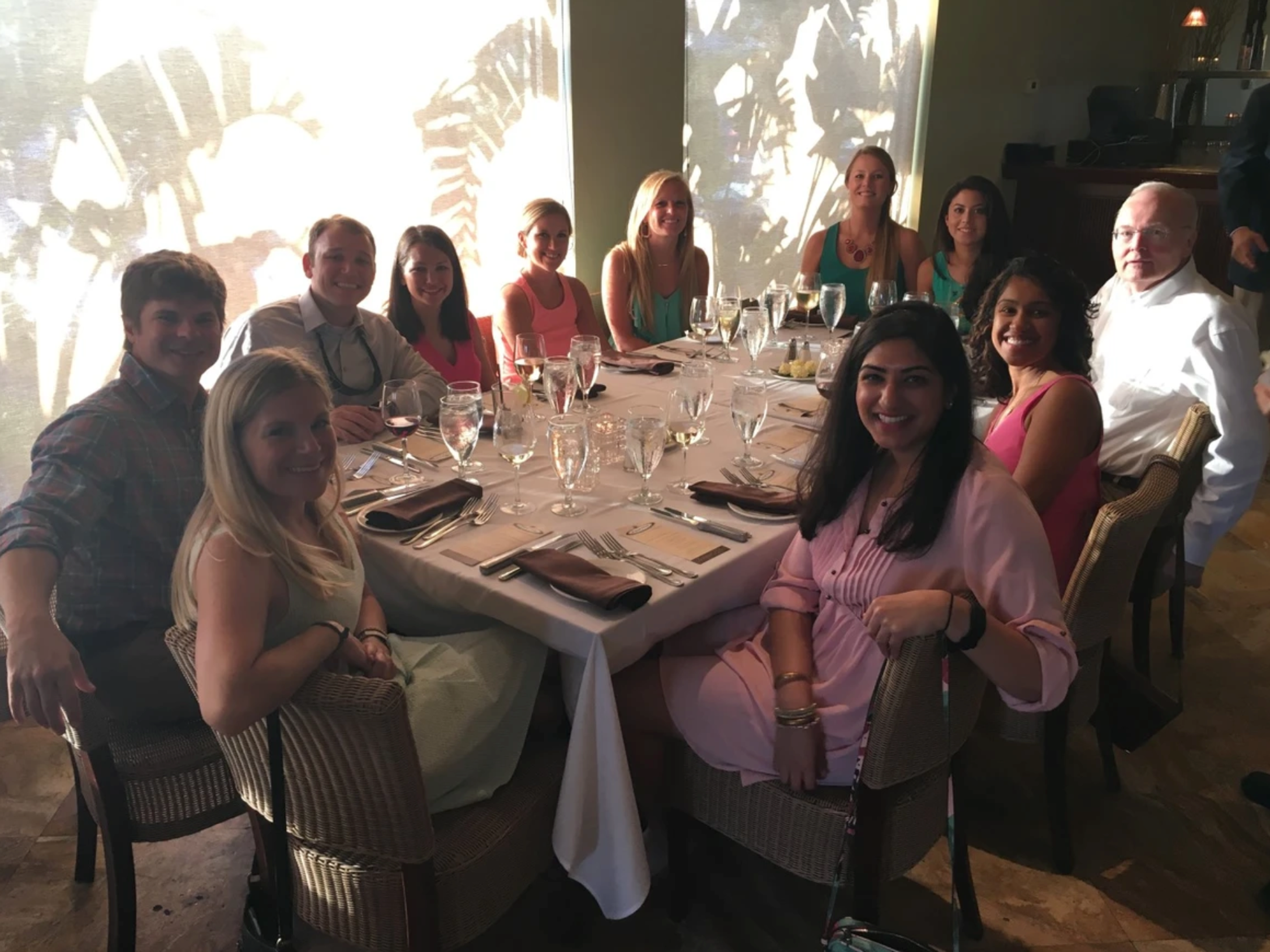 Smiling people sitting around a gala table