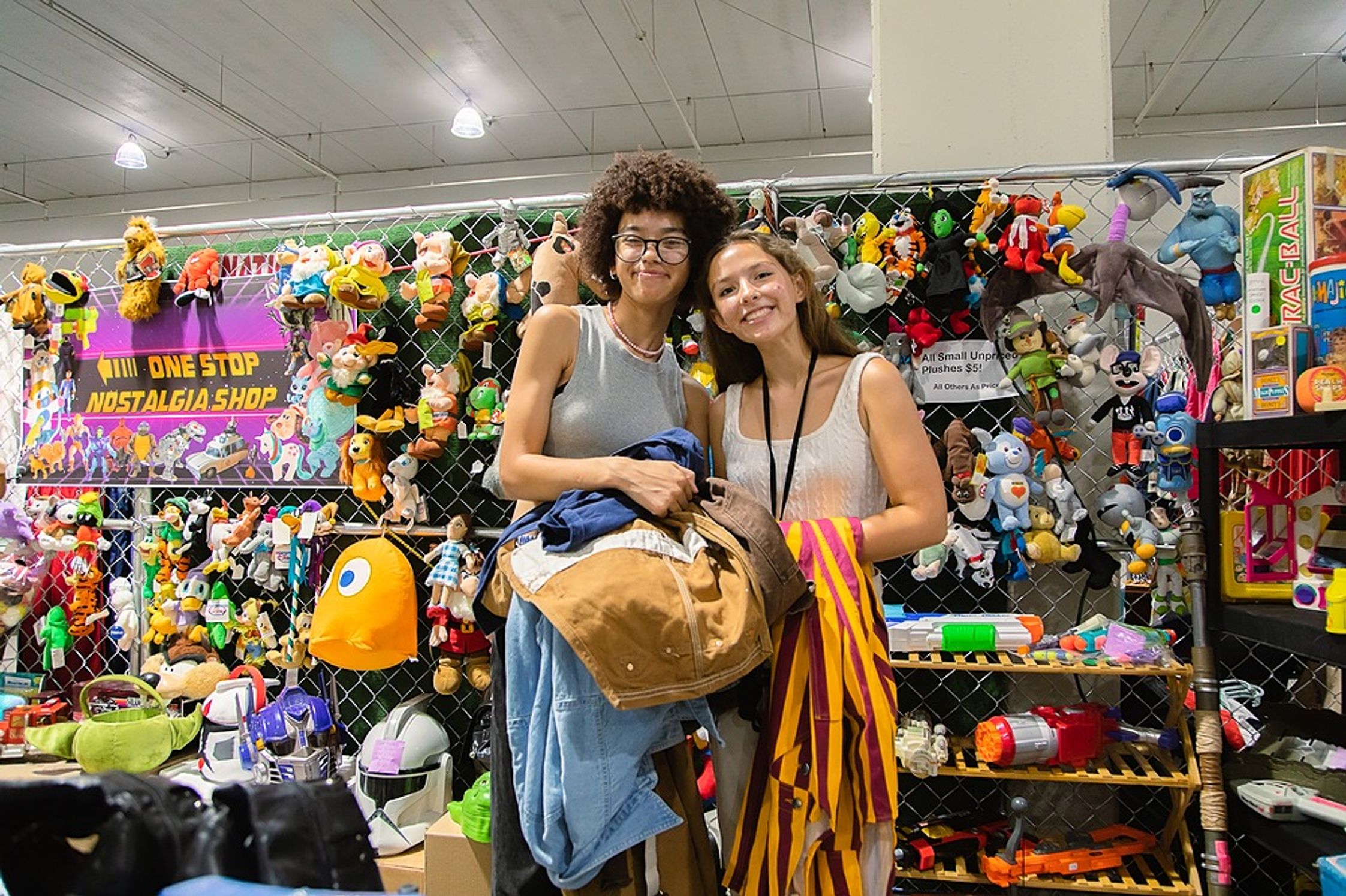 Two women smile against the backdrop of vintage goodies
