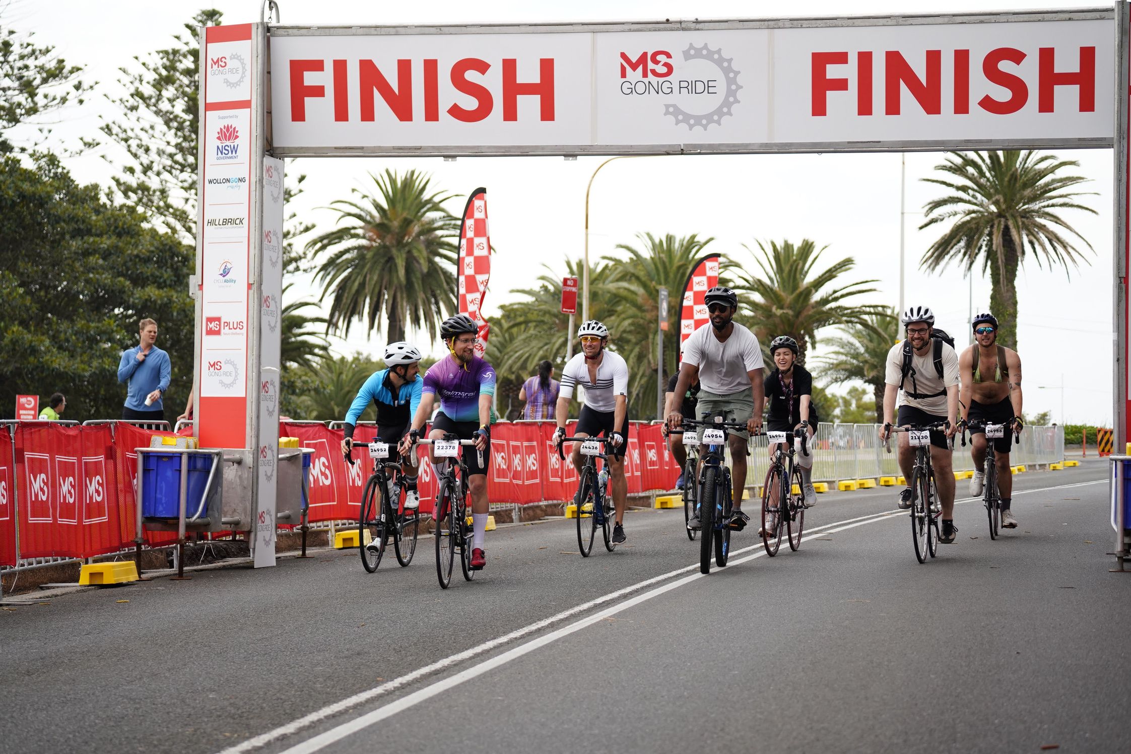 The Humanitix team riding across the finish line