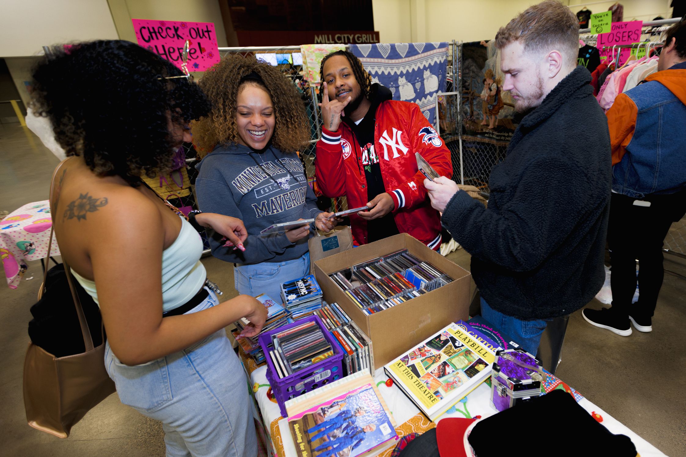 Attendees rummage through vintage CDs at the market
