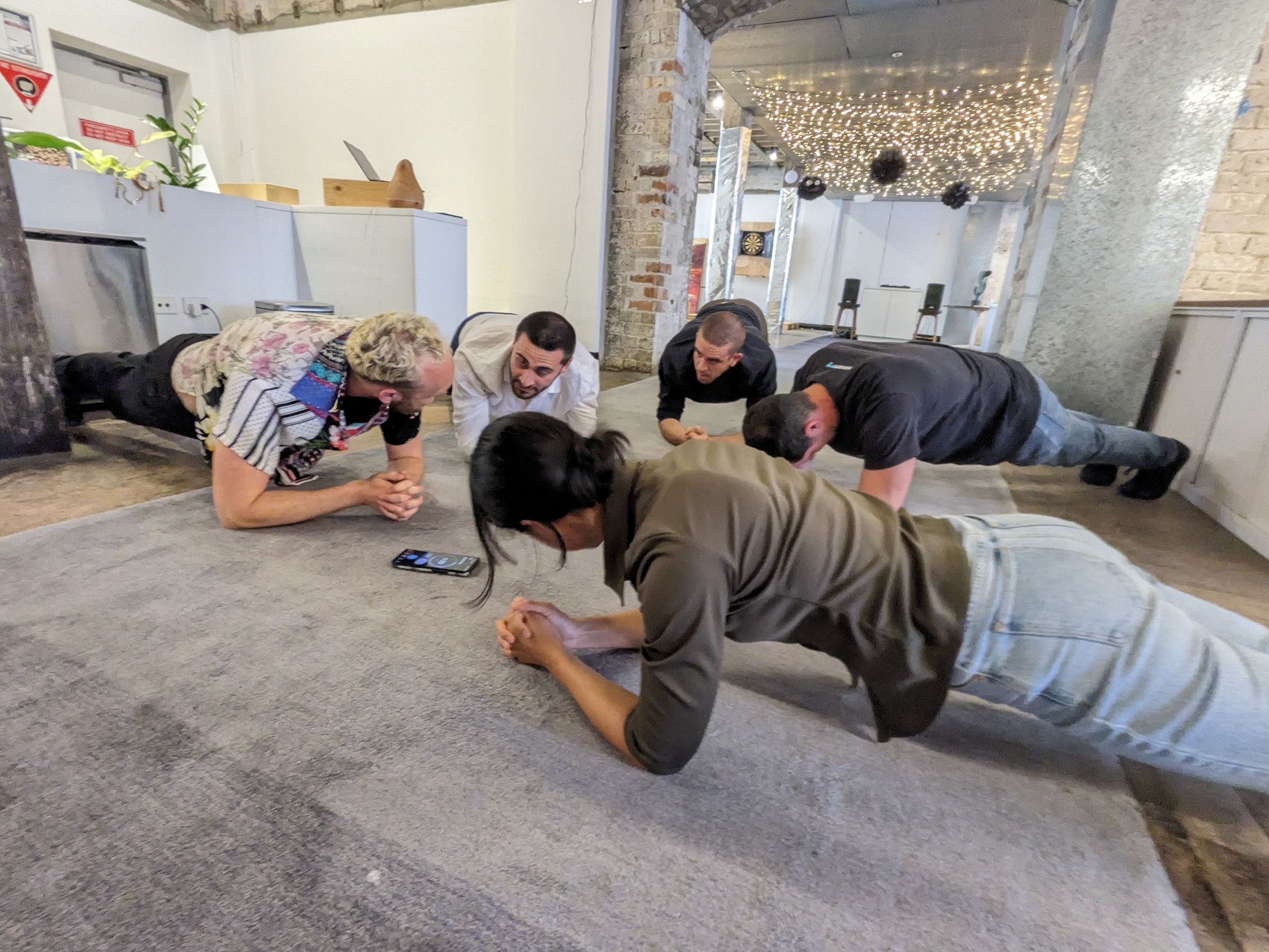Humanitix team members doing the daily plank 