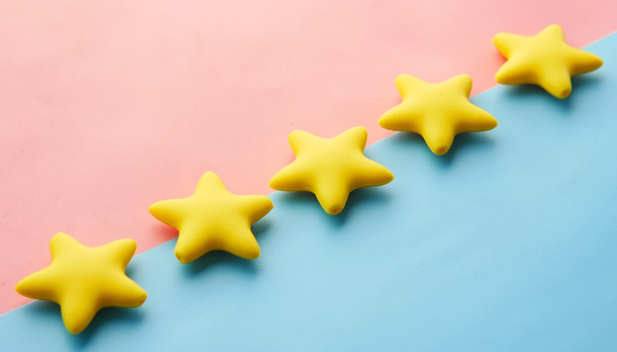 This image presents a split colour background of pink and blue with vibrant yellow stars over the top 