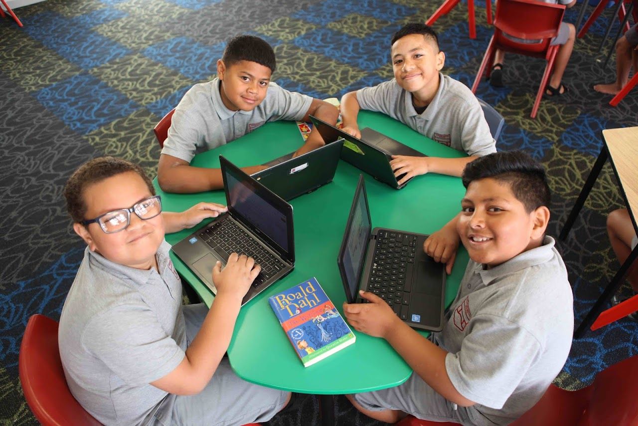 Students from Manaiakalani's digital literacy program with their laptops