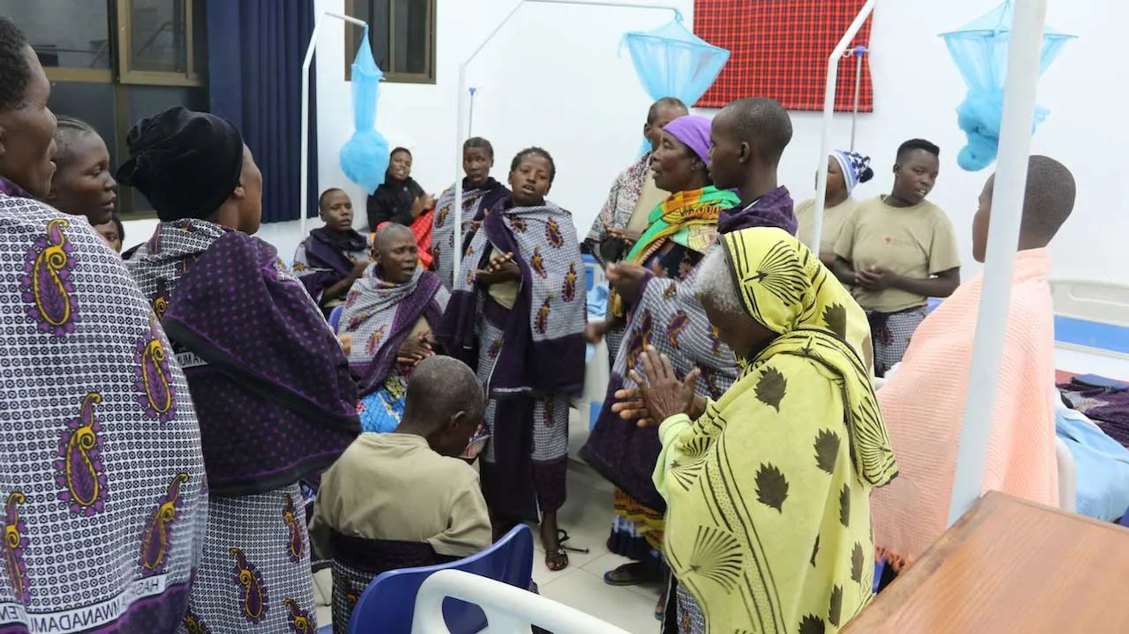 Hospital staff and patients singing and praying 