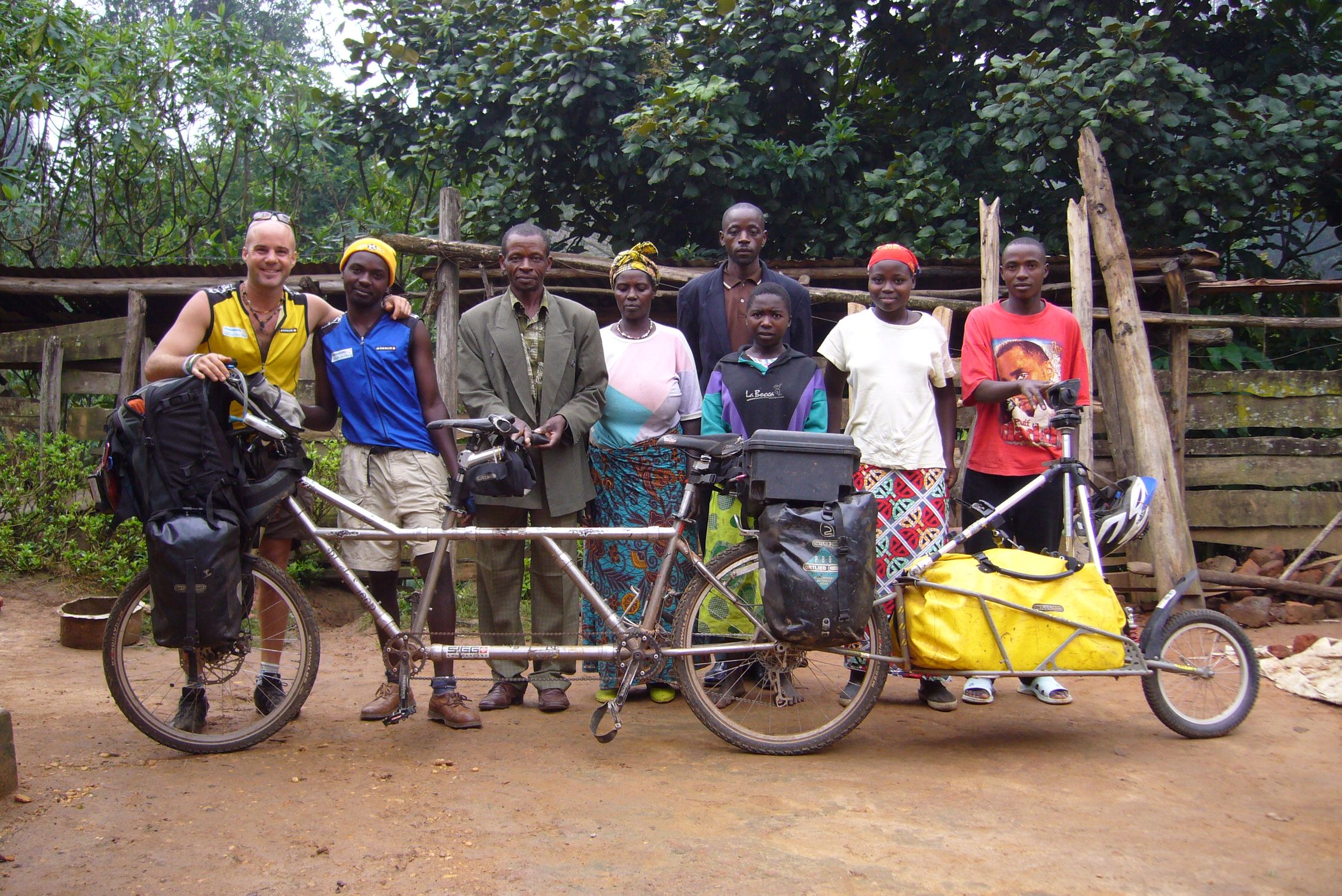 Founder D in Uganda in 2007 posing with locals and bikes