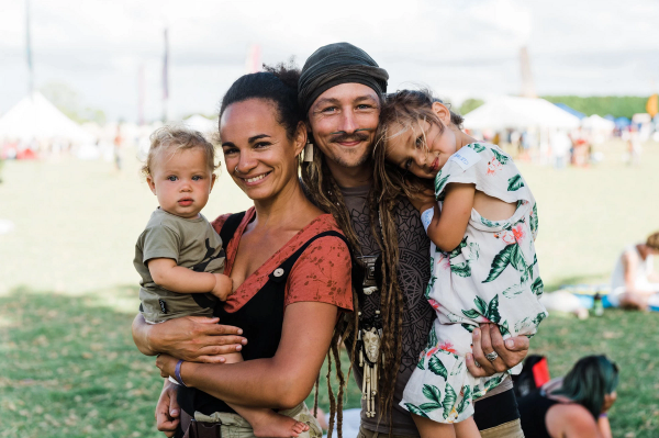 A smiling family with two kids at the festival