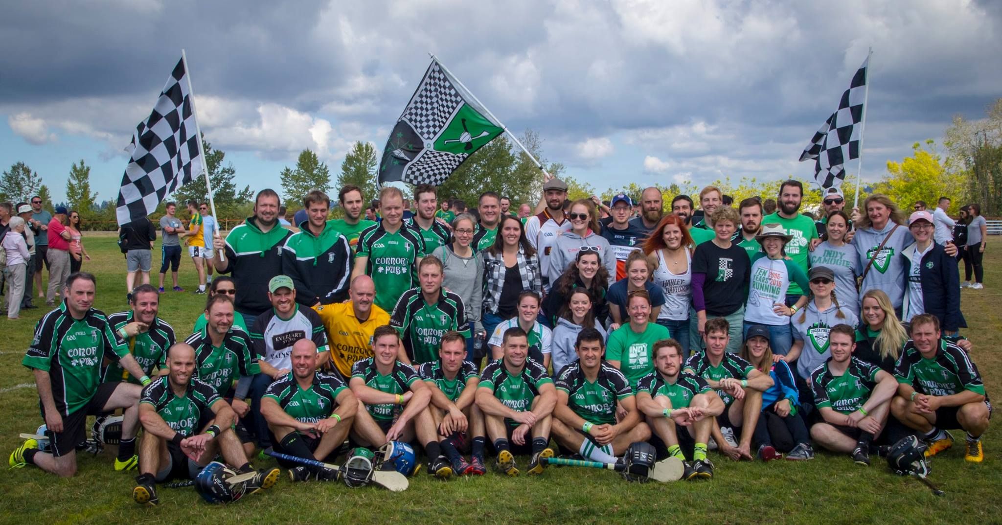 A USGAA team in green uniforms and checkered flags