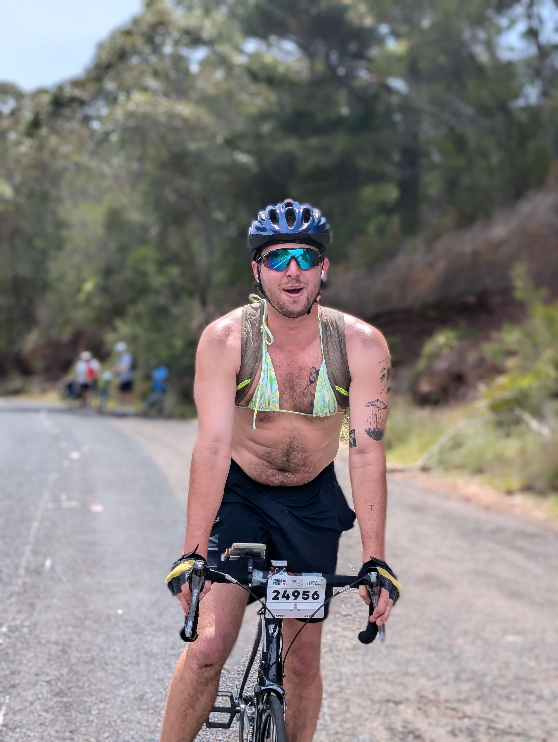 Nick riding his bike in a bikini top