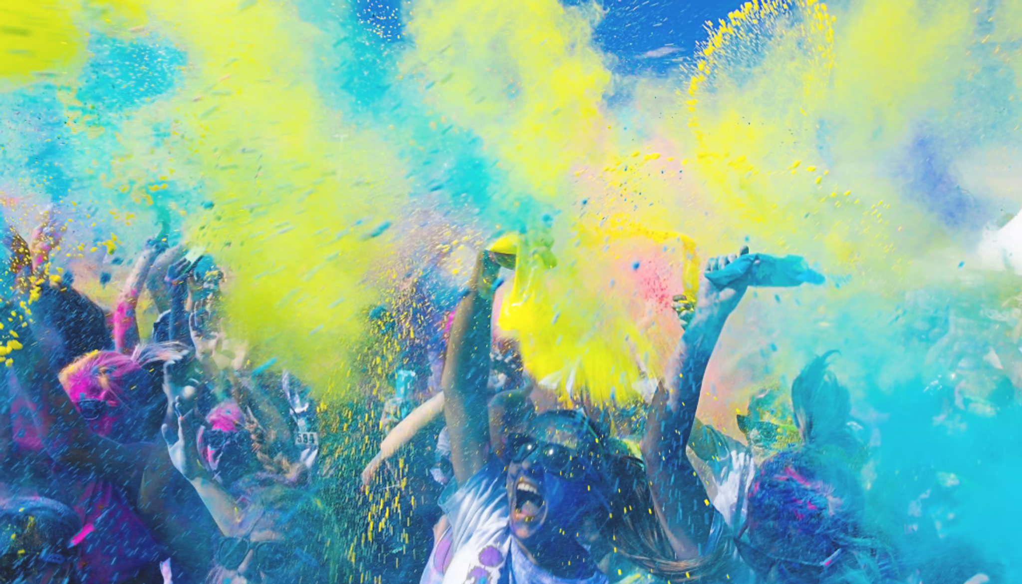 the image captures a festive event with powdered paint thrown in the air!