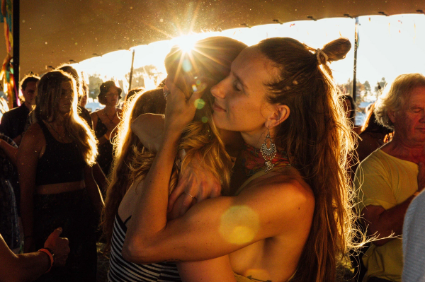 Two women hugging with the sunlight shining in the background