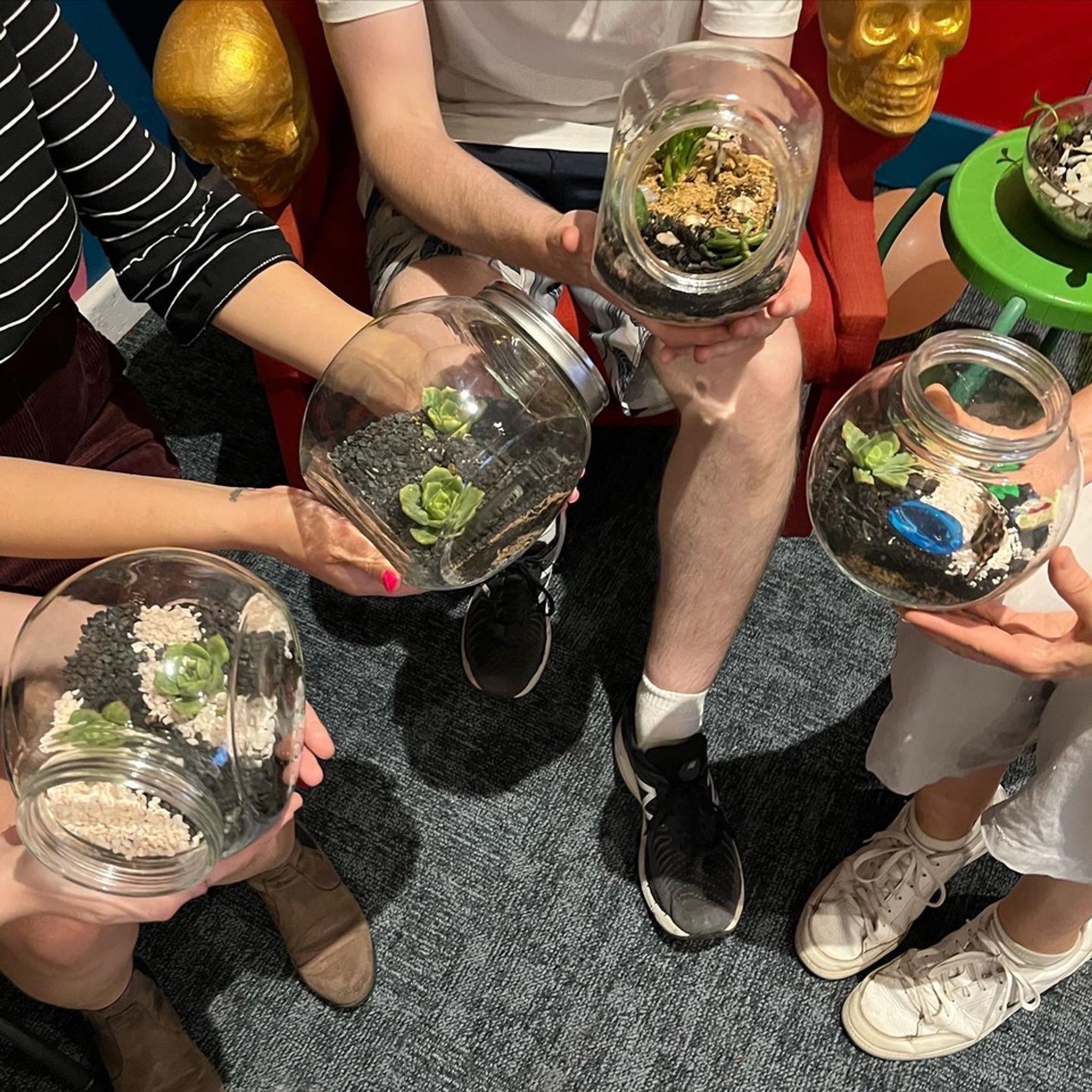 Students holding the terrariums they have made in one of Laneway Learning's classes