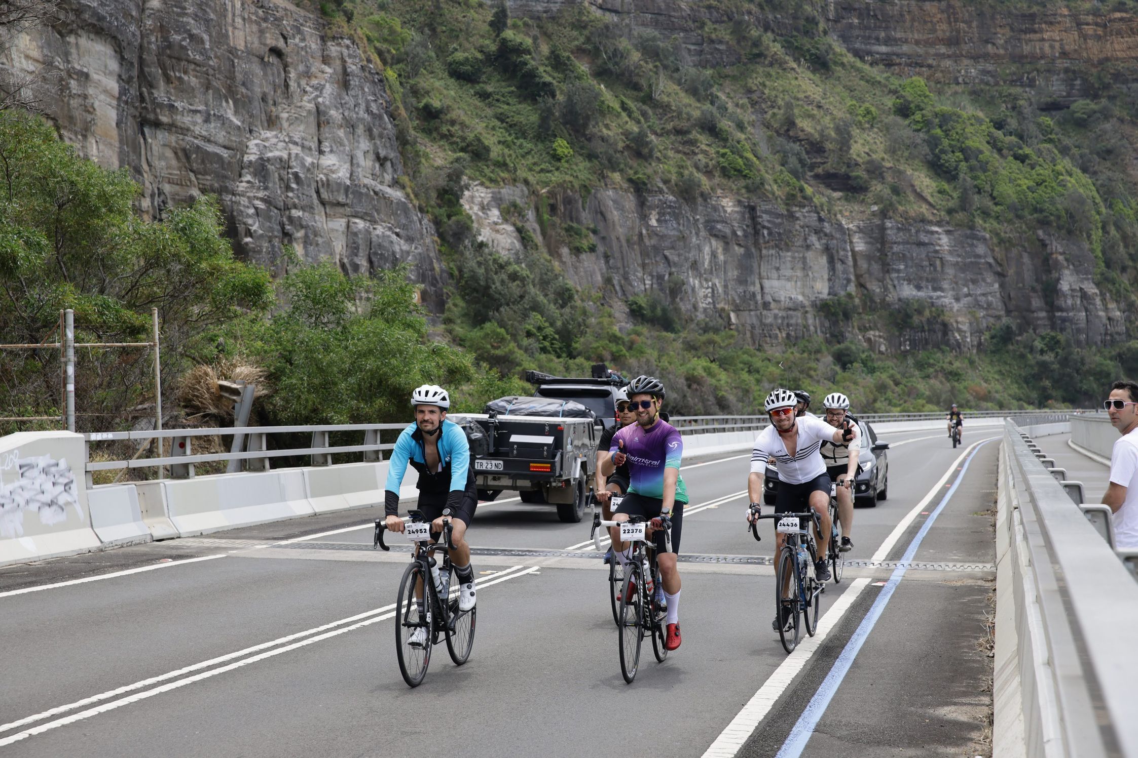 The Humanitix team cycling on the road alongside cars