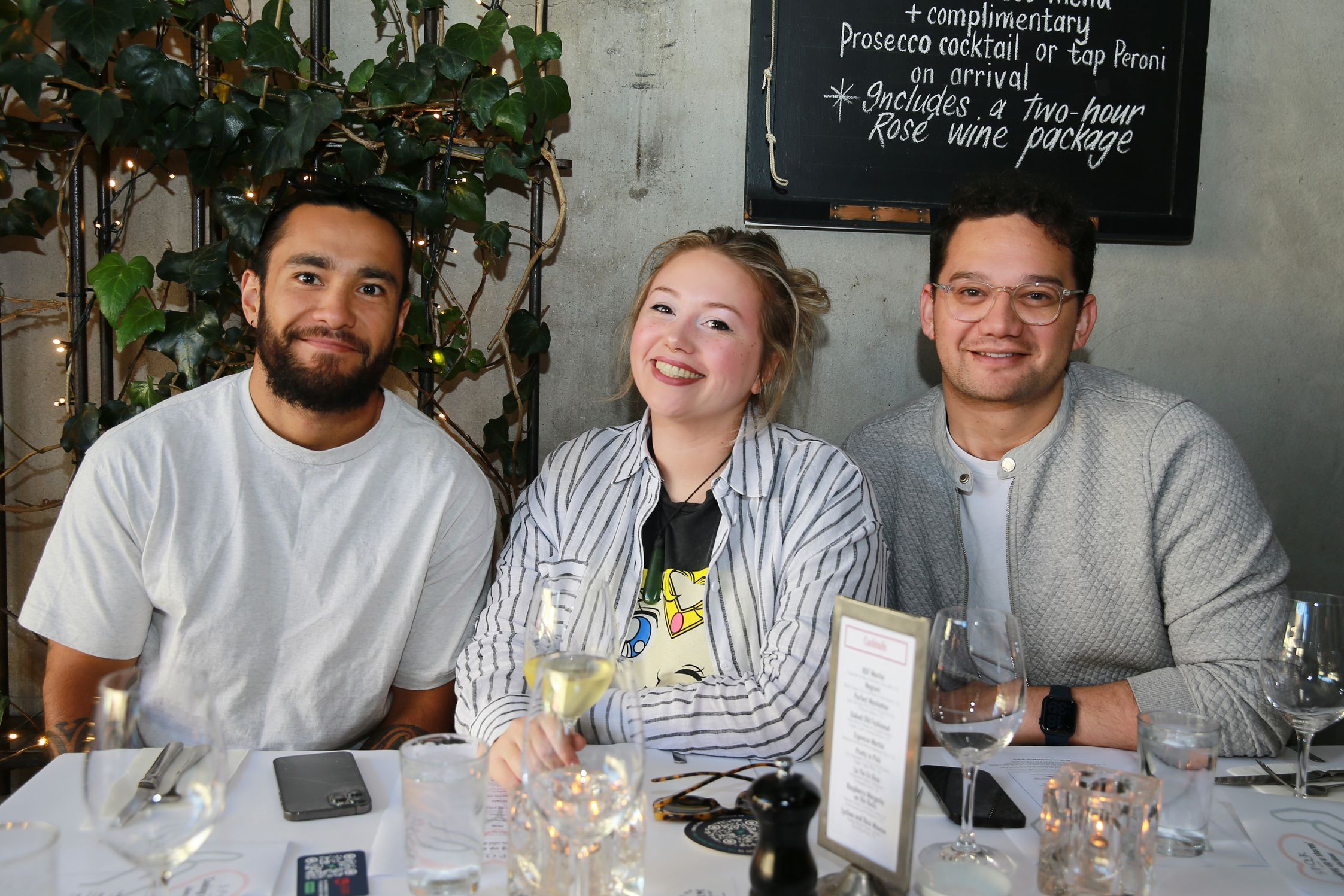 Smiling diners sitting at the table at the event