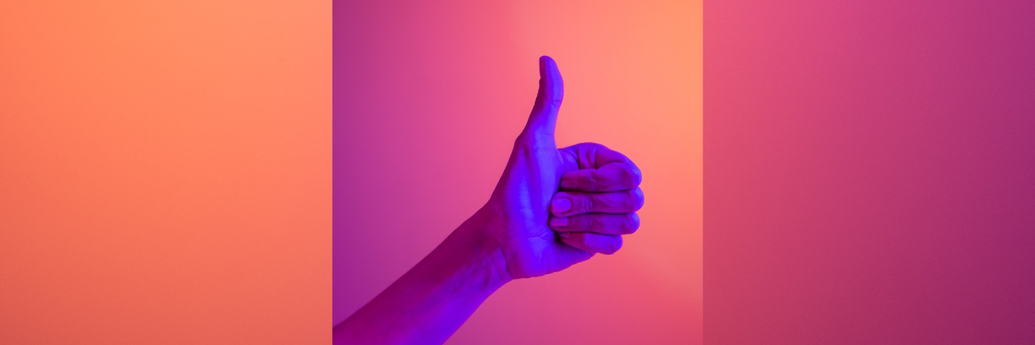 A hand giving a thumbs up on a pink background