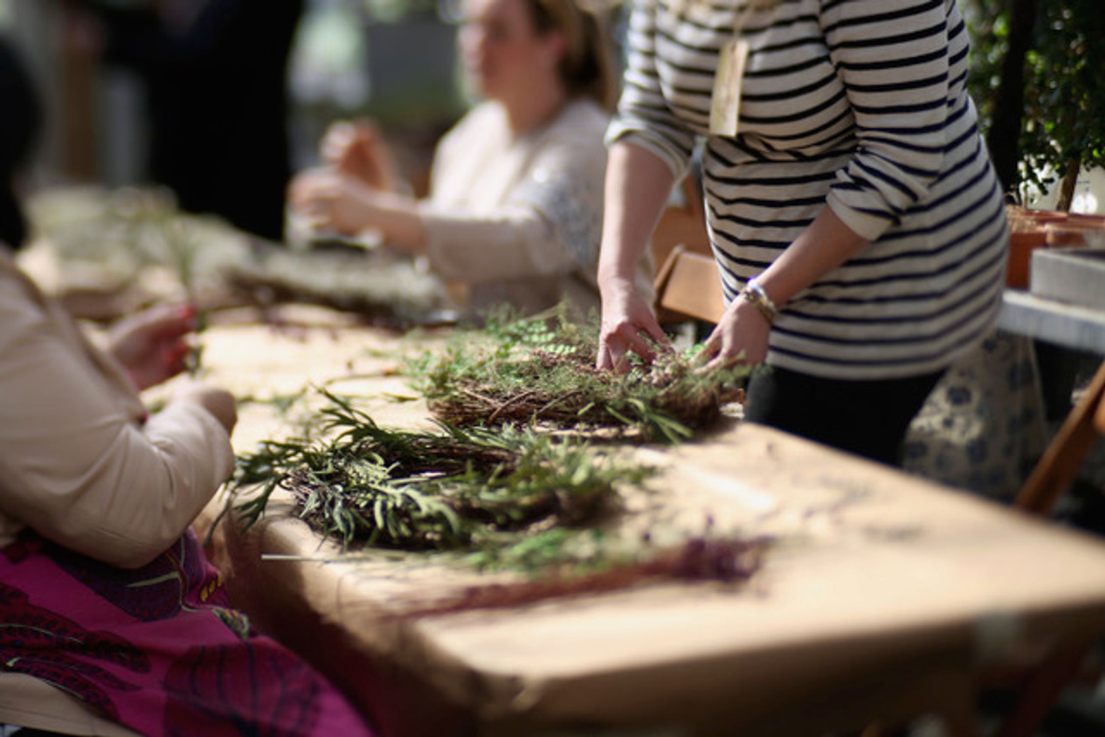 Participants working on a green wreath