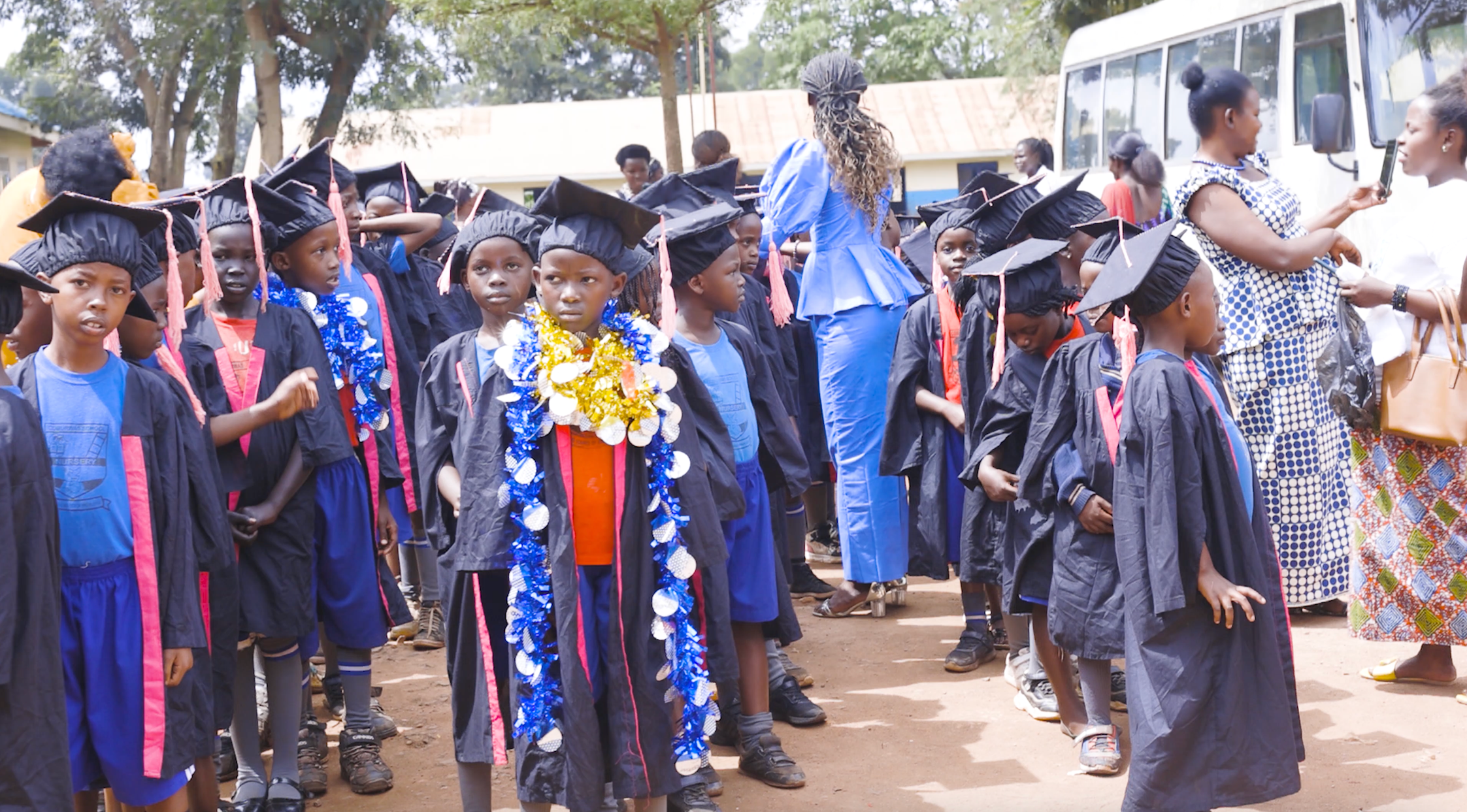 Primary school students from Uganda in graduation garb