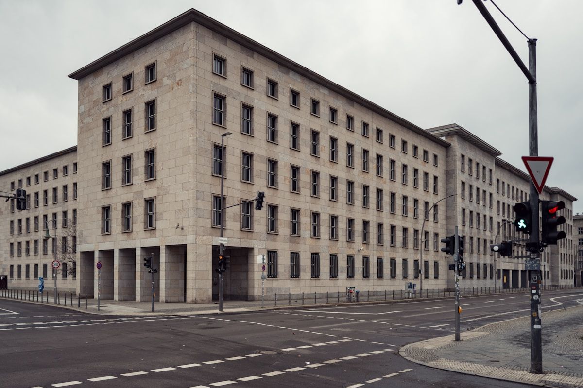 Large brutalist building on a city street corner.