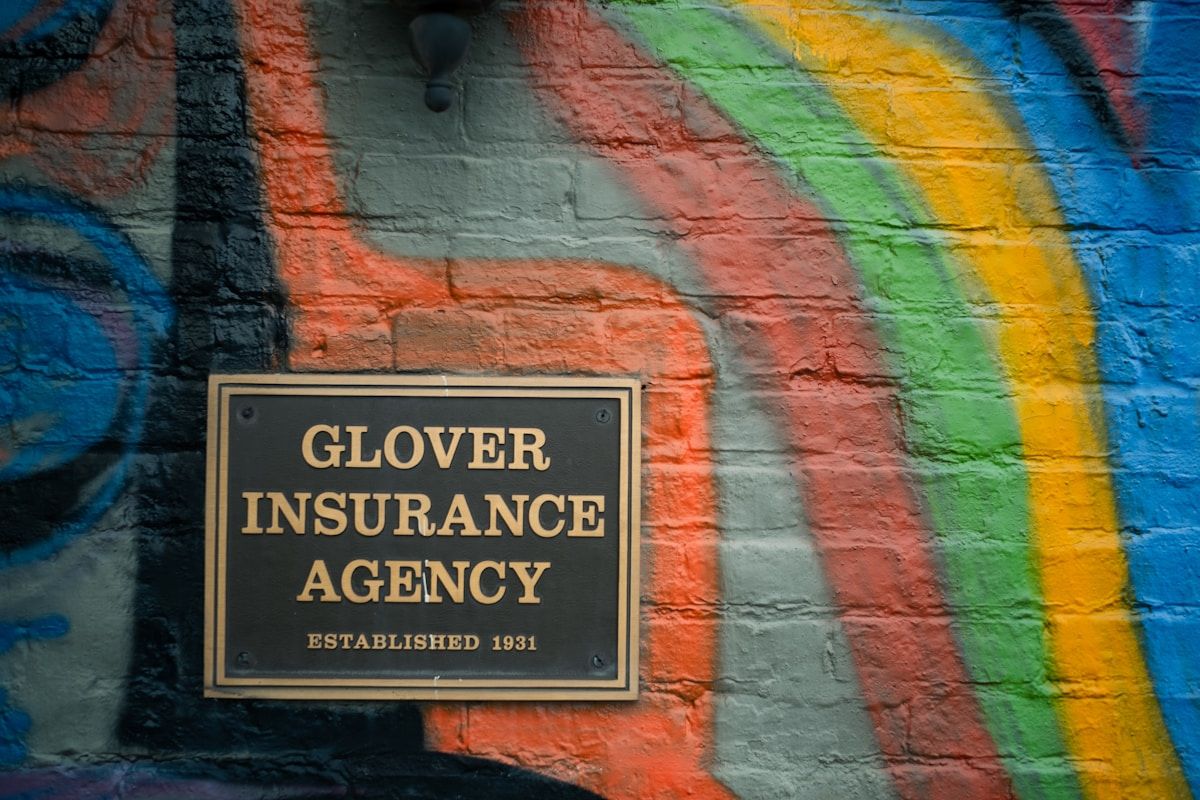a sign on a brick wall that says glover insurance agency