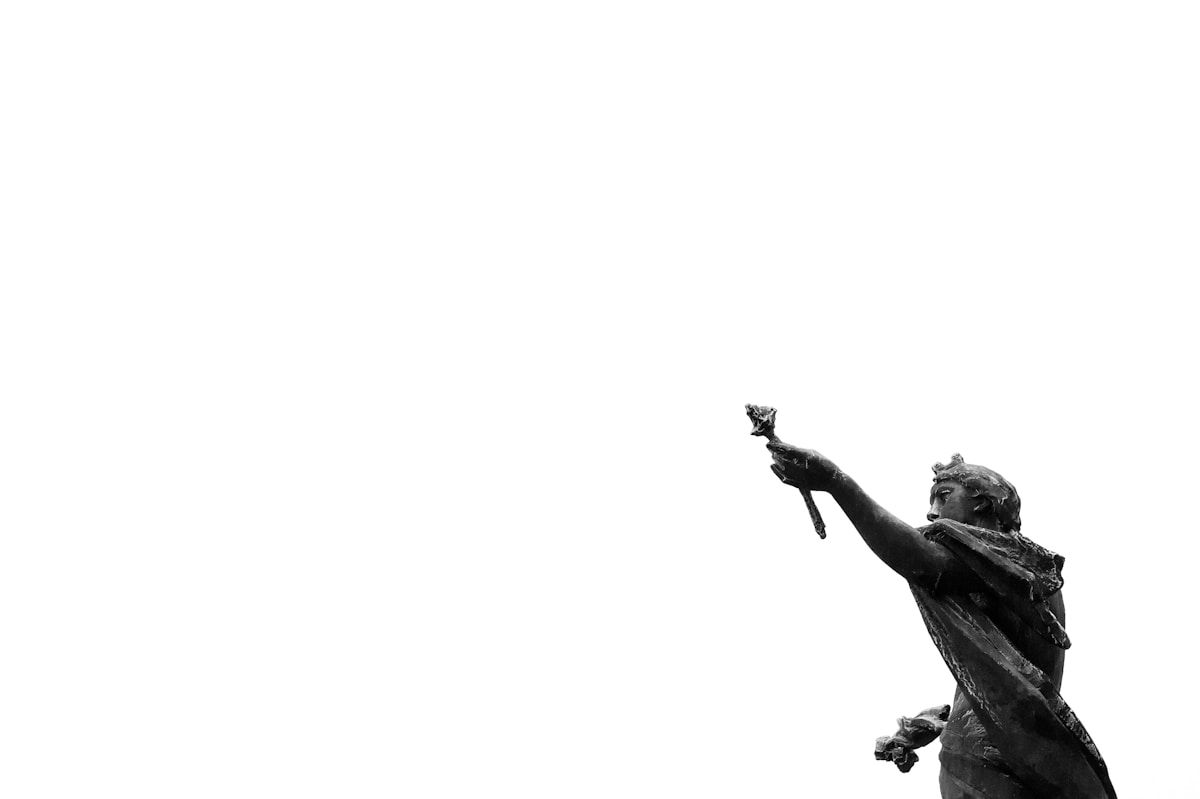 man in black jacket and pants holding camera in grayscale photography