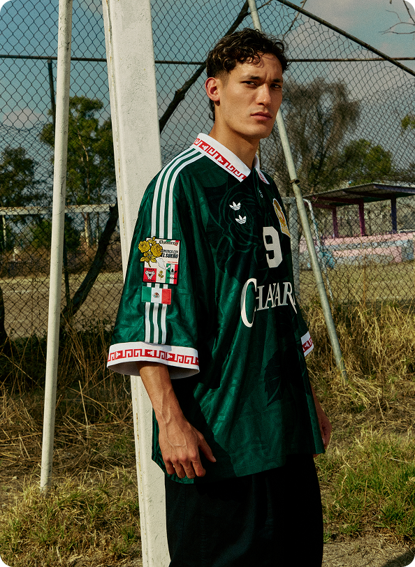 Model wearing a green WILLY CHAVARRIA and Adidas football jersey