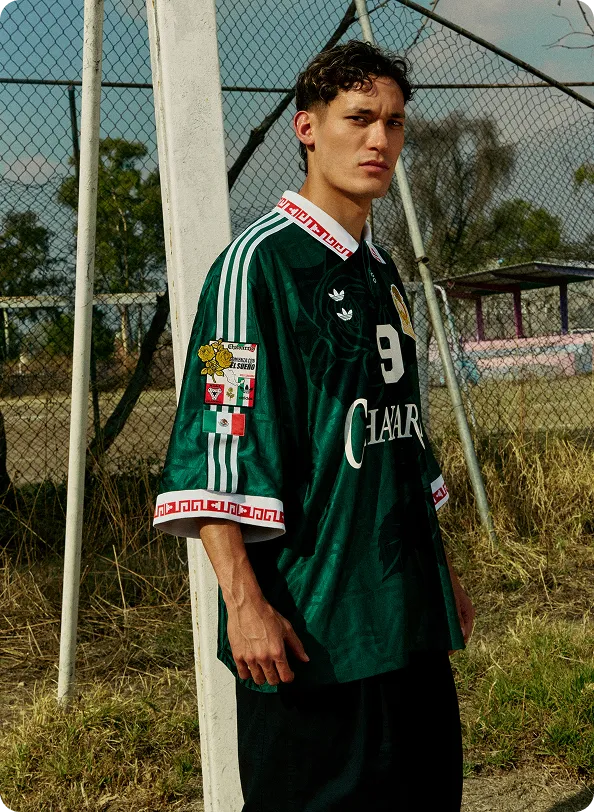 Model wearing a green WILLY CHAVARRIA and Adidas football jersey