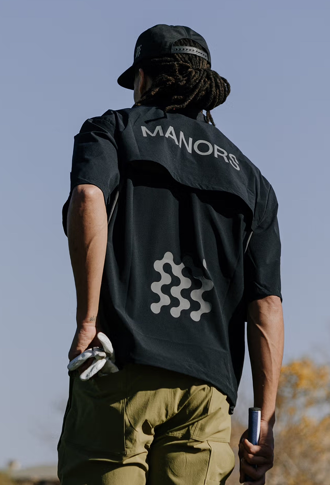 Golfer wearing Manors shirt