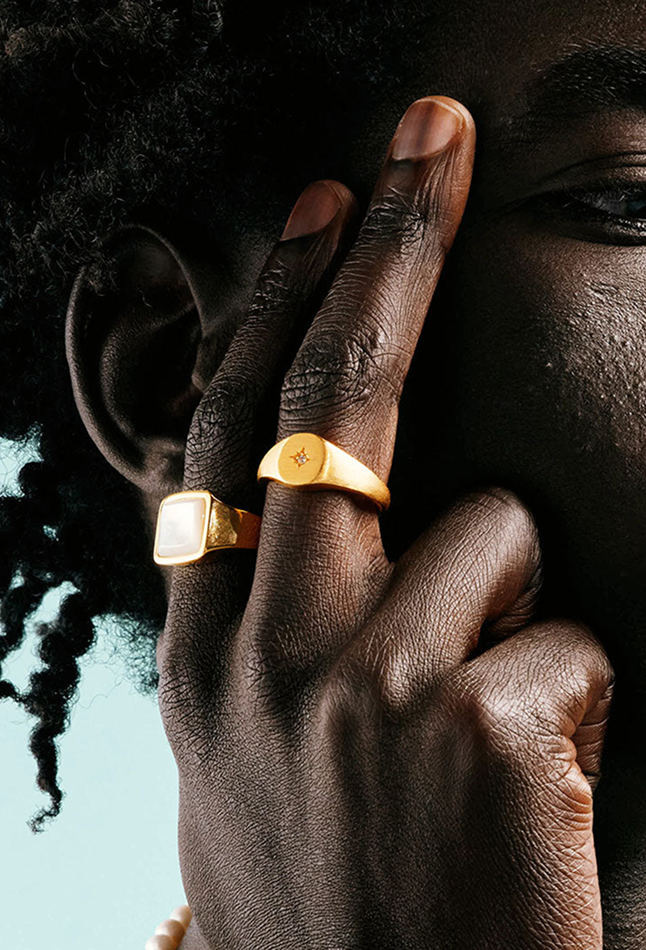 Close up of man with two fingers showing rings