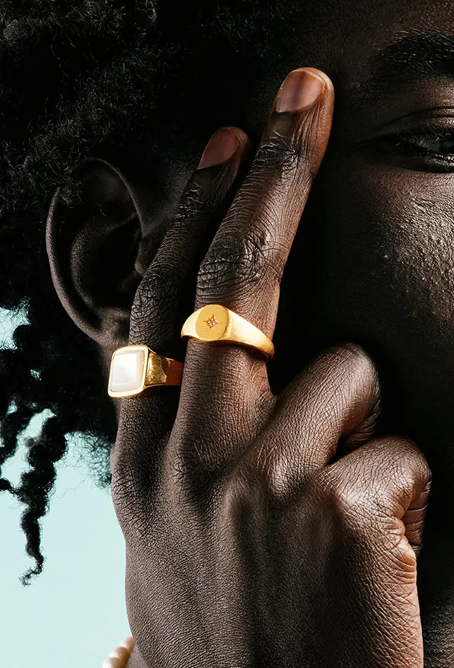 Close up of man with two fingers showing rings