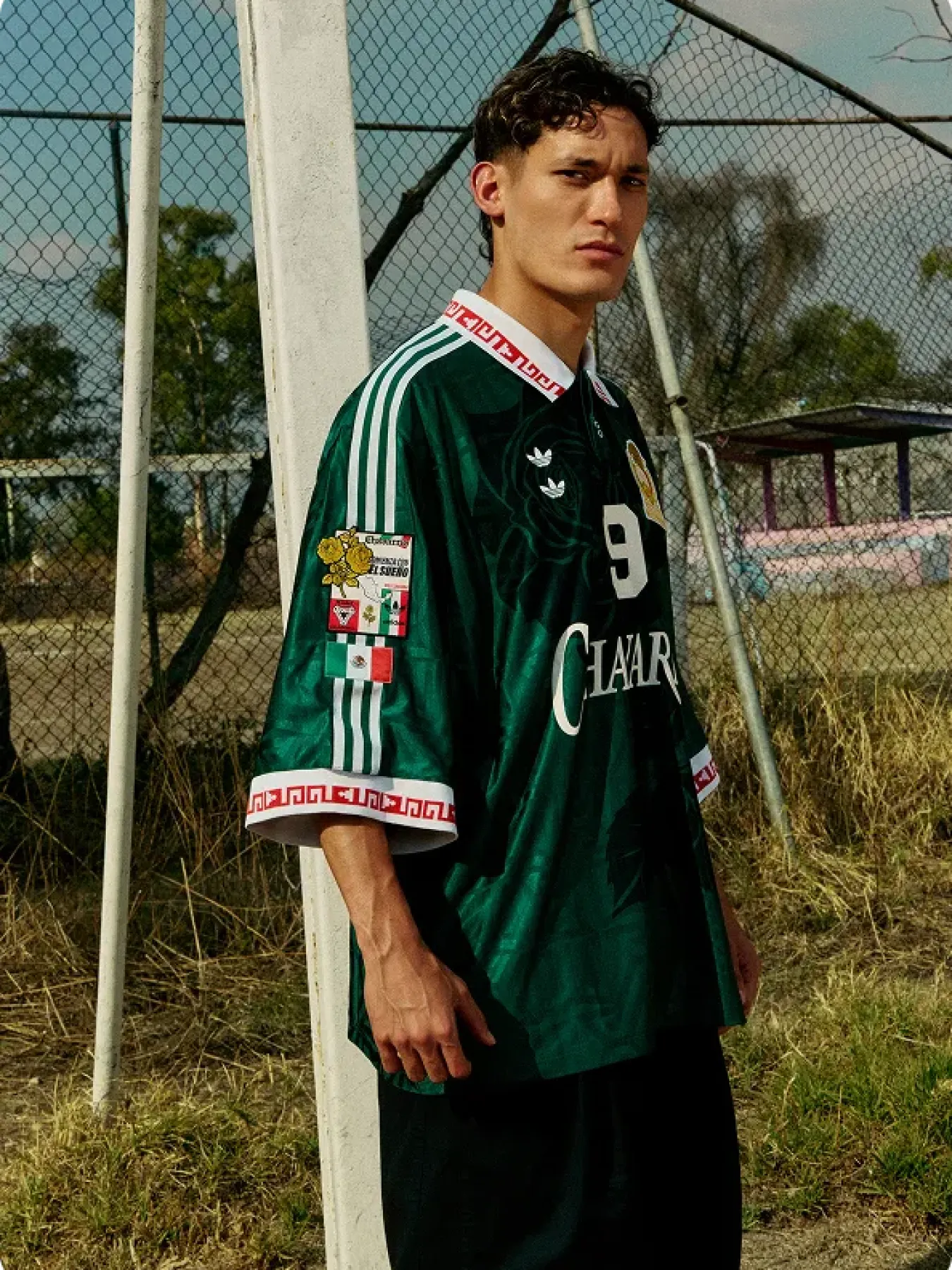 Model wearing a green Willy Chavarria jersey outdoors