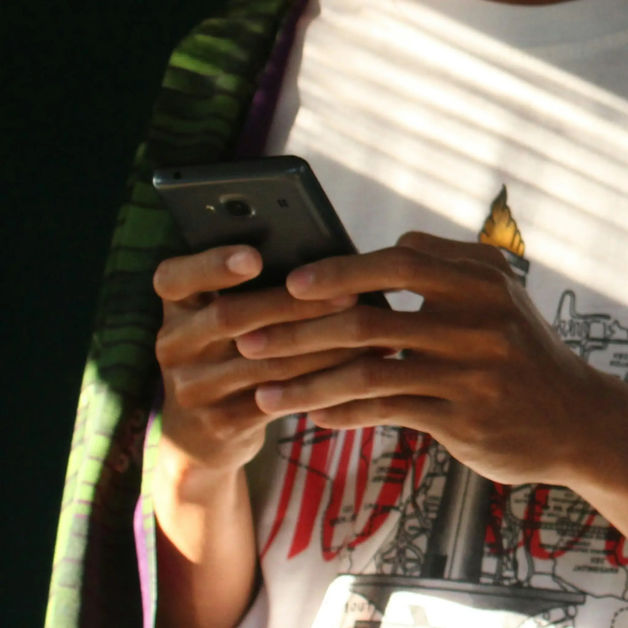 Shopper using a smartphone to research and buy products online.