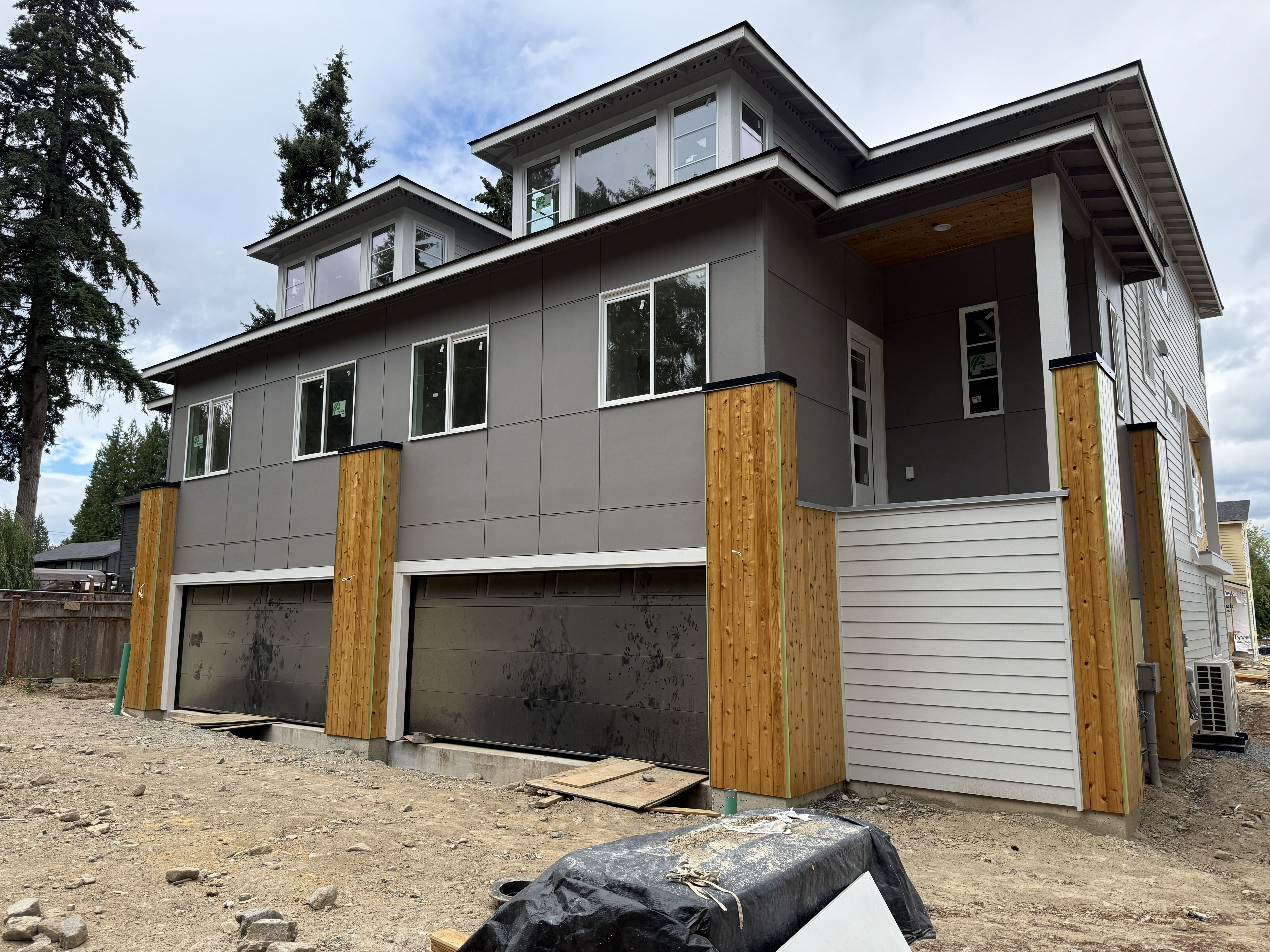 Exterior view of a finished cedar-clad home with modern architectural details