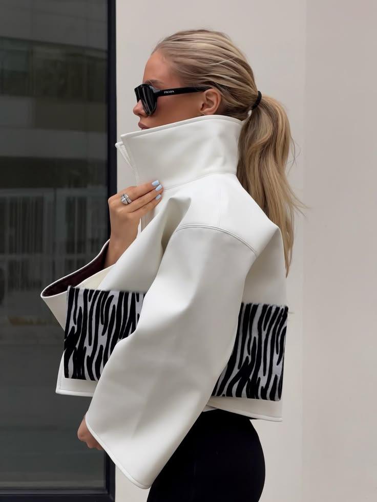 Woman in a cropped white leather jacket