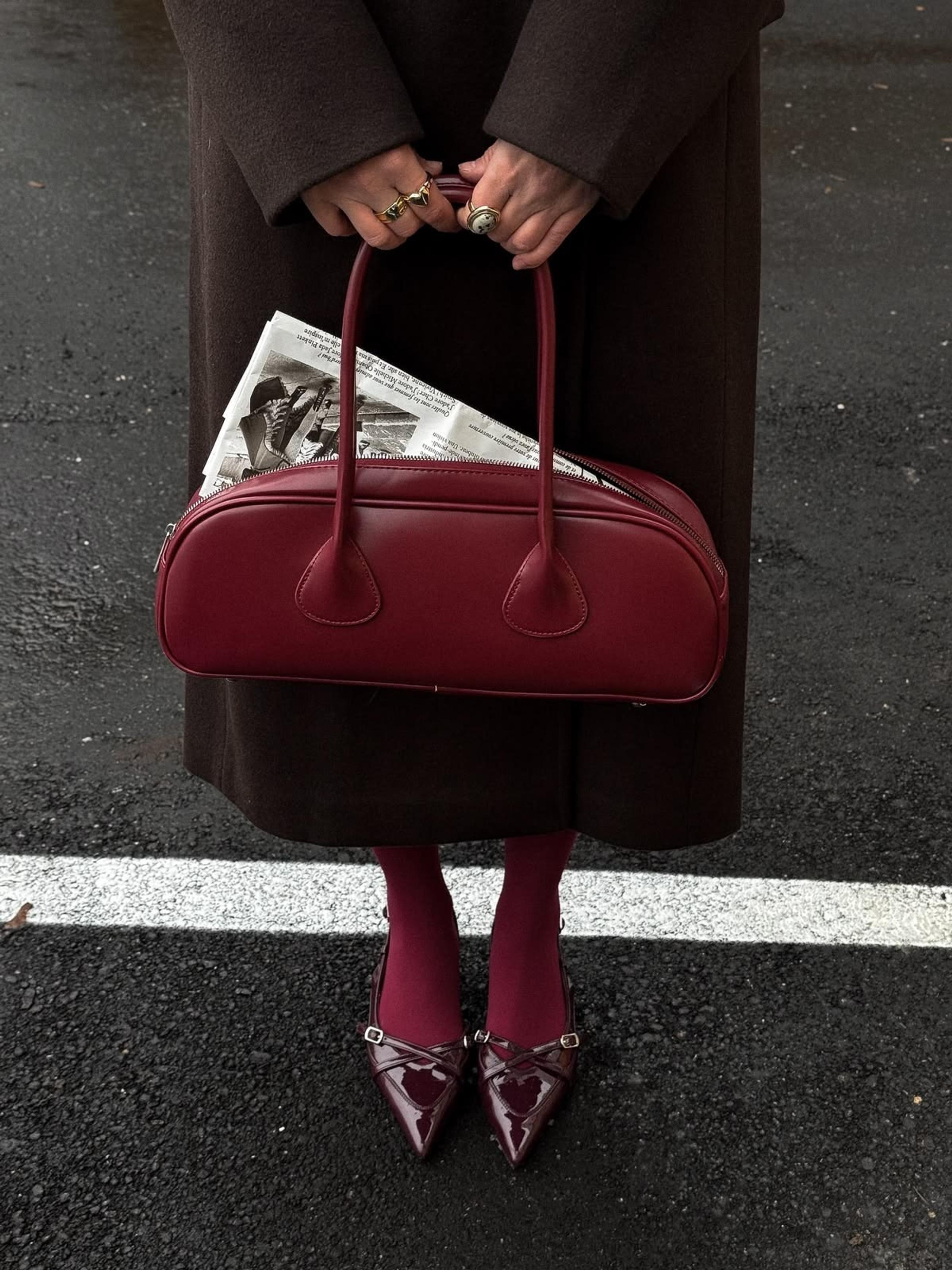 Burgundy bowling bag with burgundy tights and patent slingbacks