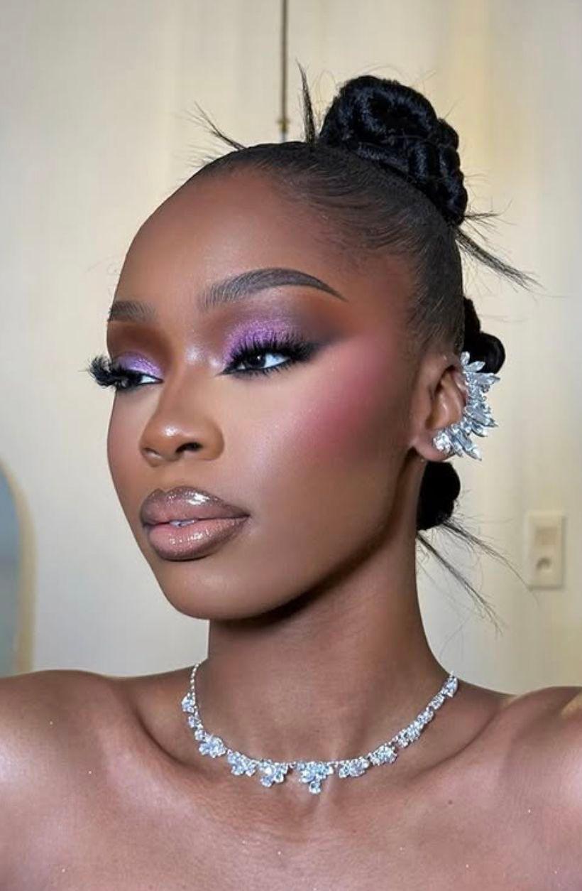 Close-up of an eye wearing a soft bronze and plum smoky eyeshadow with defined lashes